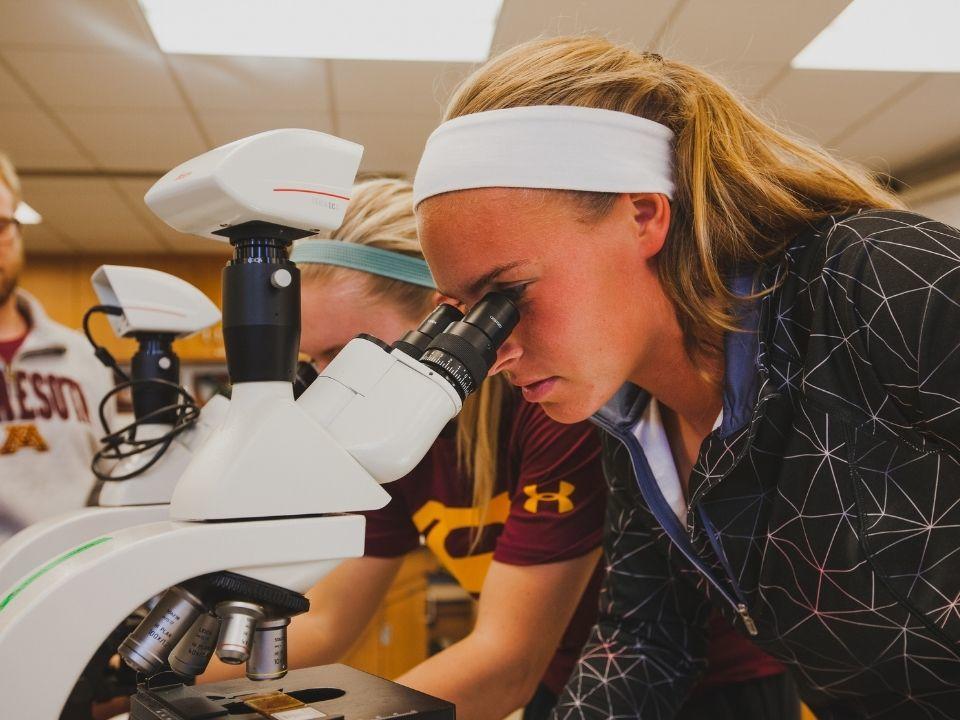 Student looking in a microscope in one of our labs