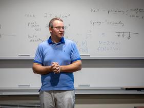 Theodore Chapman, math instructor in front of a white board at U of M Crookston